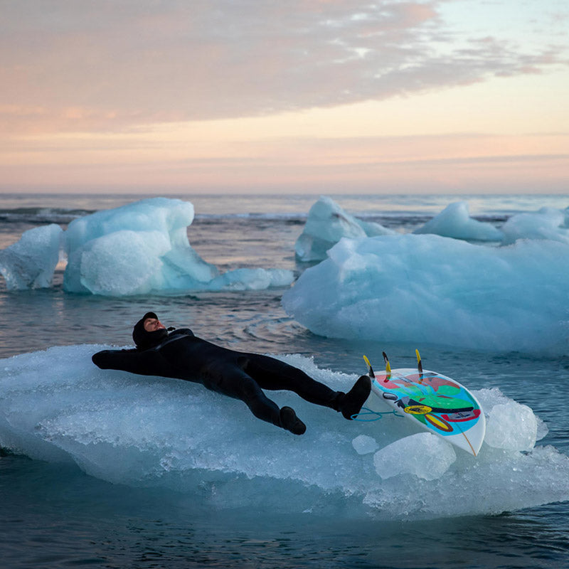 Jesse Mendes laying on his back on an iceberg in iceland