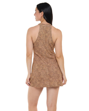 A woman shown from the back wearing a sleeveless halter-neck mini dress with an allover leopard print pattern in brown and beige, set against a plain white background.